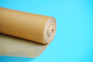 A roll of baking paper on a blue background.