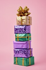 Colorful wrapped gifts stacked with a shiny bow for a festive celebration