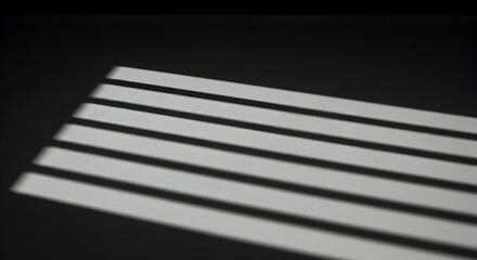 Window Blinds Creating Striped Shadows on Surface with Dark Background