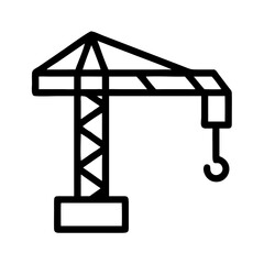 Construction crane stands tall at the building site during the day with a clear sky in the background