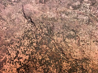 Weathered Stone Surface with Dark Patches and Cracks in Bangkok