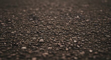 Close Up View of Dark Sand and Pebbles on Ground Surface