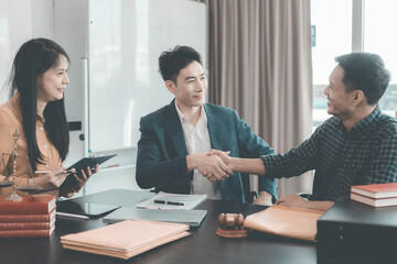 Businessmen shaking hands to make a deal with their partner lawyer, discussing contract agreement, legal concept, advice and justice, good service cooperation.