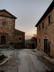 Quiet evening in an ancient village street with historic buildings and a soft sunset glow