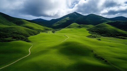 Lush green meadows, rolling hills, and distant mountains. Scenic aerial view of a valley
