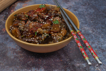 Vegan Korean eggplant side dish gaji namul in serving bowl with chopsticks