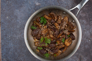 Vegan Korean eggplant gaji namul  in stainless steel pan on gray background, copy space