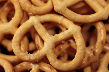 Extreme Close Up (Macro) Of Salty Pretzel Snacks. Detailed Texture Of Baked Dough And Salt Crystals. Food Background Or Appetizer Concept. Top View.