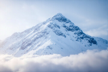Majestic Snow-Capped Mountain Peak with Pristine White Snow, Dramatic Ridges, and Clouds, Serene Nature Landscape, Grand Scenic View