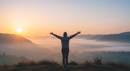 Fototapeta premium Sunrise Serenity: A Person's Embrace of Misty Mountain Majesty
