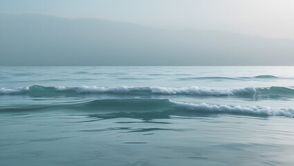 The sun kisses blue ocean waves breaking on the sandy beach along the summer coast wallpaper