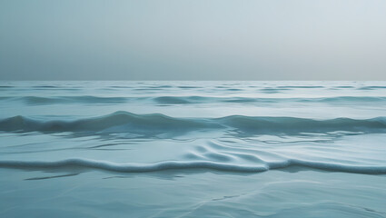 Blue sea waves crash on the sandy beach under a summer sky near the horizon, a beautiful seascape of nature's calm