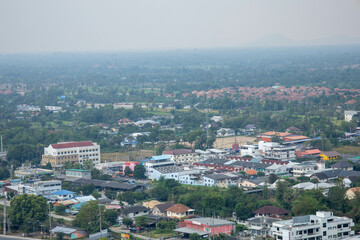 An aerial view of the city skyline of Phetchaburi, with mountains in the background.