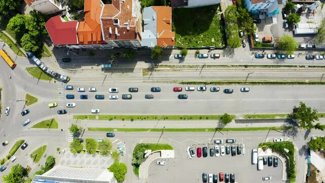 Establishing aerial footage of city streets with traffic and a monument on a roundabout