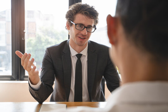 interviewer on the table asking question applicant in the office.