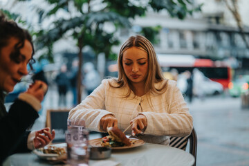 Two women share a meal at a bustling city cafe, enjoying time together outdoors. The scene showcases urban life, friendship, and a cozy atmosphere, perfect for social moments in an urban setting.