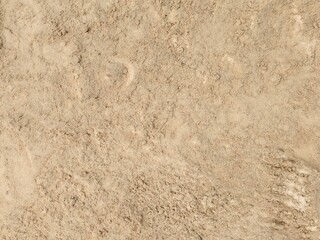 Soil or Mud! Brown ground surface, Close up natural background. Soil wall texture of clay house structure. Fine beach sand, Soil wall of clay house structure, mud background. Vintage tone.