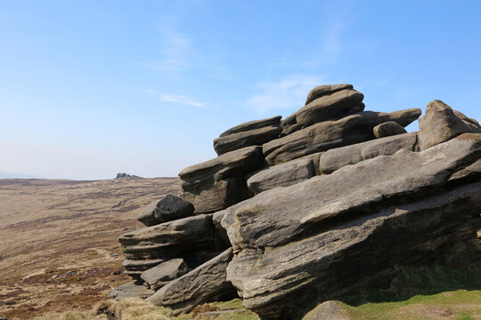View past a rock outcrop towards Pym Chair, Edale Moor Derbyshire England
