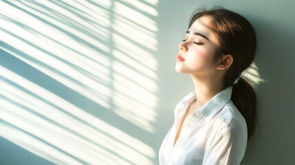 Fototapeta premium Woman with long hair in white shirt gazing up at the warm, bright sun in a clear sky