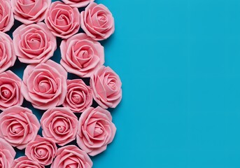 Pink paper roses border on turquoise background