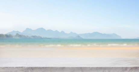 Selective focus.Marble top table on blur sea beach landscape