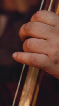 Fat bearded man plays tovshuur at folk music concert focus on hand and instrument neck. Altai musical rituals. Entertainment at ethnic festival