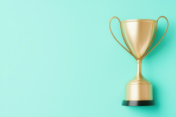 Fototapeta premium golden trophy stands proudly on black pedestal against vibrant mint green background, symbolizing achievement and success. This elegant award captures essence of victory and celebration