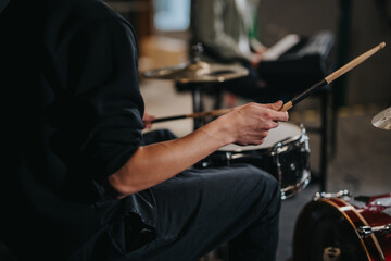 Musicians rehearse during a band practice focusing on rhythm and harmony