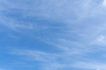 Low angle view of beautiful blue sky with strange shape of thin white clouds in the morning or evening in sunny day used as natural background texture in decorative art work