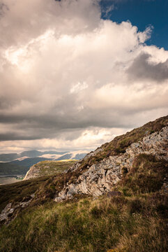 A summer HDR image of sunlight catching Knockan Crag with the Sutherland Mountains in the background.