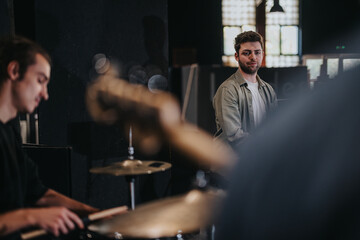 A group of musicians rehearsing in a studio space, focusing on their musical instruments and coordination. This captures the essence of creativity, teamwork, and dedication during a practice session.