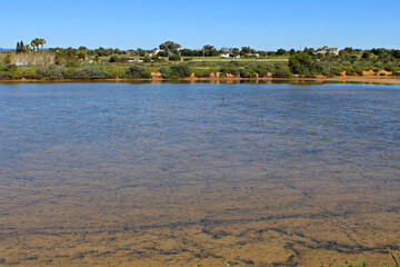 Salt Pans in Ria Formosa Natural Park in Fuseta, Algarve, Portugal. Highlighting the tranquil beauty of this protected wetland ecosystem