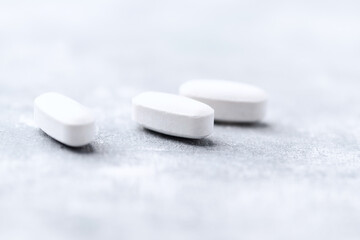 Amino acids tablets on wooden background. Soft focus. Close up	