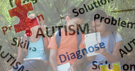 Image of colourful puzzle pieces and autism text over school children using tablets © vectorfusionart