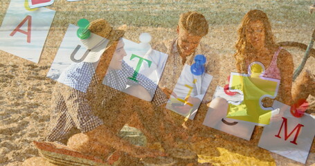 Image of colourful puzzle pieces and autism text over happy friends using tablet in beach
