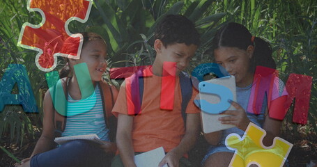 Image of colourful puzzle pieces and autism text over school children using tablets