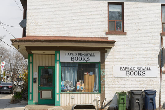 exterior building facade and ghost signs of Pape And Dingwall Books, now closed, located at 517 Pape in Toronto, Canada (Dingwall Av side)