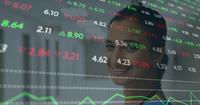 Image of financial data processing over smiling biracial female doctor