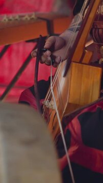 Musician performs playing igil bow instrument at tribal concerts on stage closeup. Traditions of Altai music. Meditative sound and inspiring show