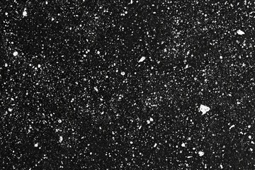 Black surface with scattered white specks