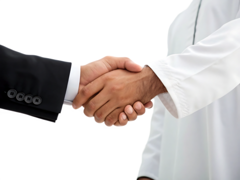 A close up shot of a handshake between a person in a suit and a person in arab clothing attire