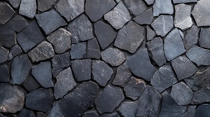 Fototapeta premium Stone Wall Texture: A close-up view reveals a striking stone wall texture, showcasing the natural patterns and textures of individual stones. Ideal for conveying a sense of strength, history.