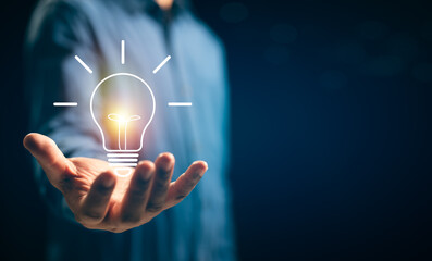 Businessman hands showing light bulb for thinking new idea concept. Innovative technology with...