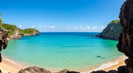 Fototapeta premium A breathtaking view of a pristine beach with clear, turquoise water and rocky cliffs on a sunny day.