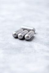 BCAA amino acids tablets. Nutrition for bodybuilding. Fitness supplements on bright background. Soft focus. Copy space.	