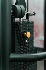 sstkWellness showcases the structure and precision of strength training through this image of a pin-loaded weight machine, designed for both safety and performance. This type of resistance equipment f