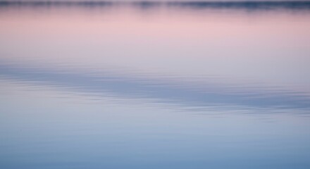 Ethereal Water Dance Soft pink  blue hues blend in a calm rippled lake reflecting the sky at dawn