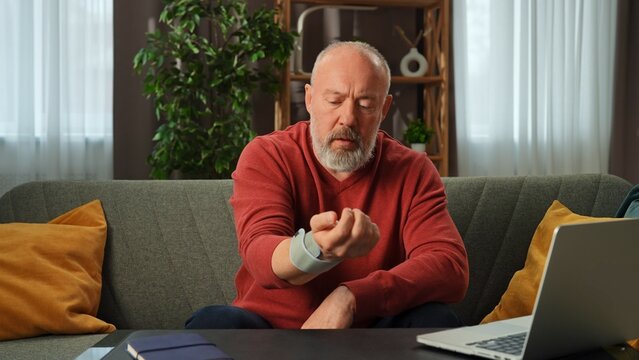 Sick Senior Man Using Tissue While Sitting at Home