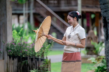 Smiling Thai Woman Holding Traditional Umbrella in Lanna Dress