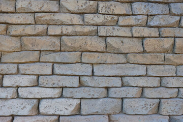 Rustic Stone Wall Texture Made of Irregular Beige Bricks